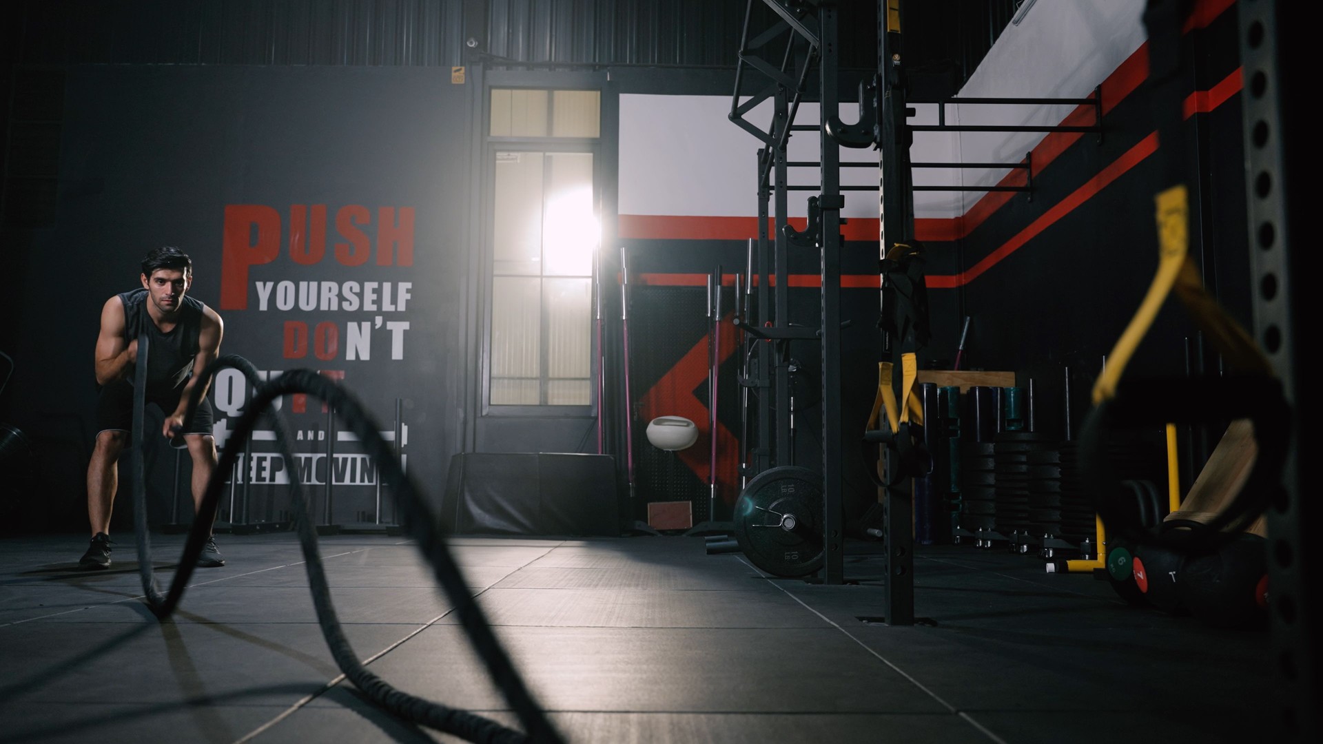 Sport man Workout Exewith Battle Rope Training Building Muscles and Burning Fat Cardio, Healthy Lifestyle in Fitness Gym.